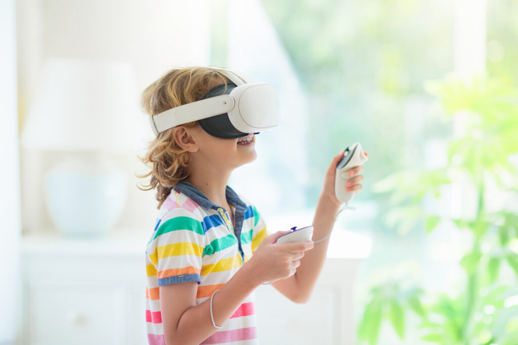 Child in virtual reality goggles. VR set for kids.