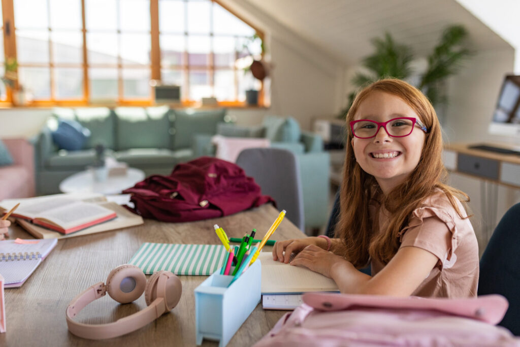 Portrait of a happy girl studying at home