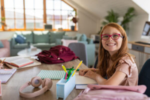 Portrait of a happy girl studying at home