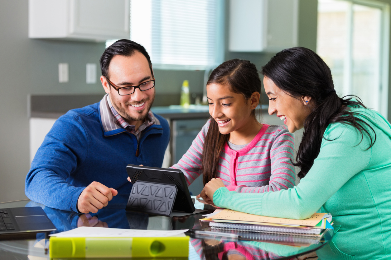 Hispanic mom and dad homeschool pre teen daughter