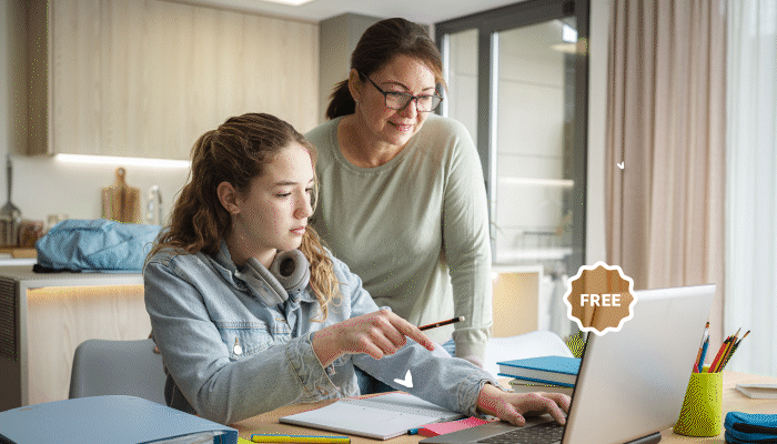 Mom and daughter looking at computer in their homeschooling workspace